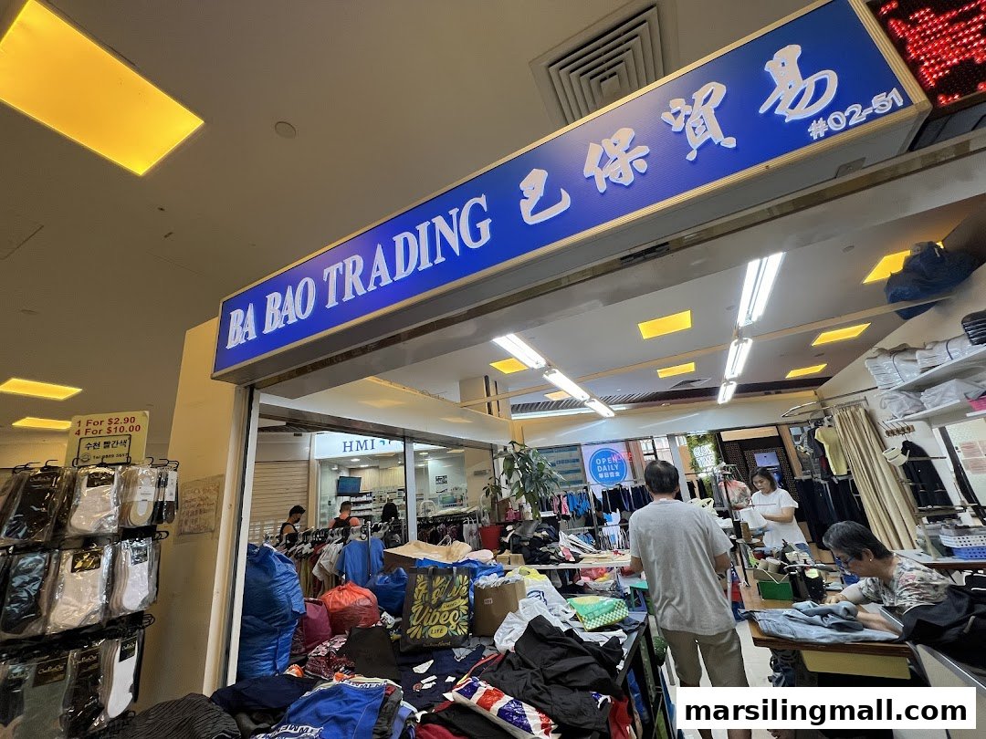 The entrance of Ba Bao Trading, a bustling shop offering clothing and alteration services.