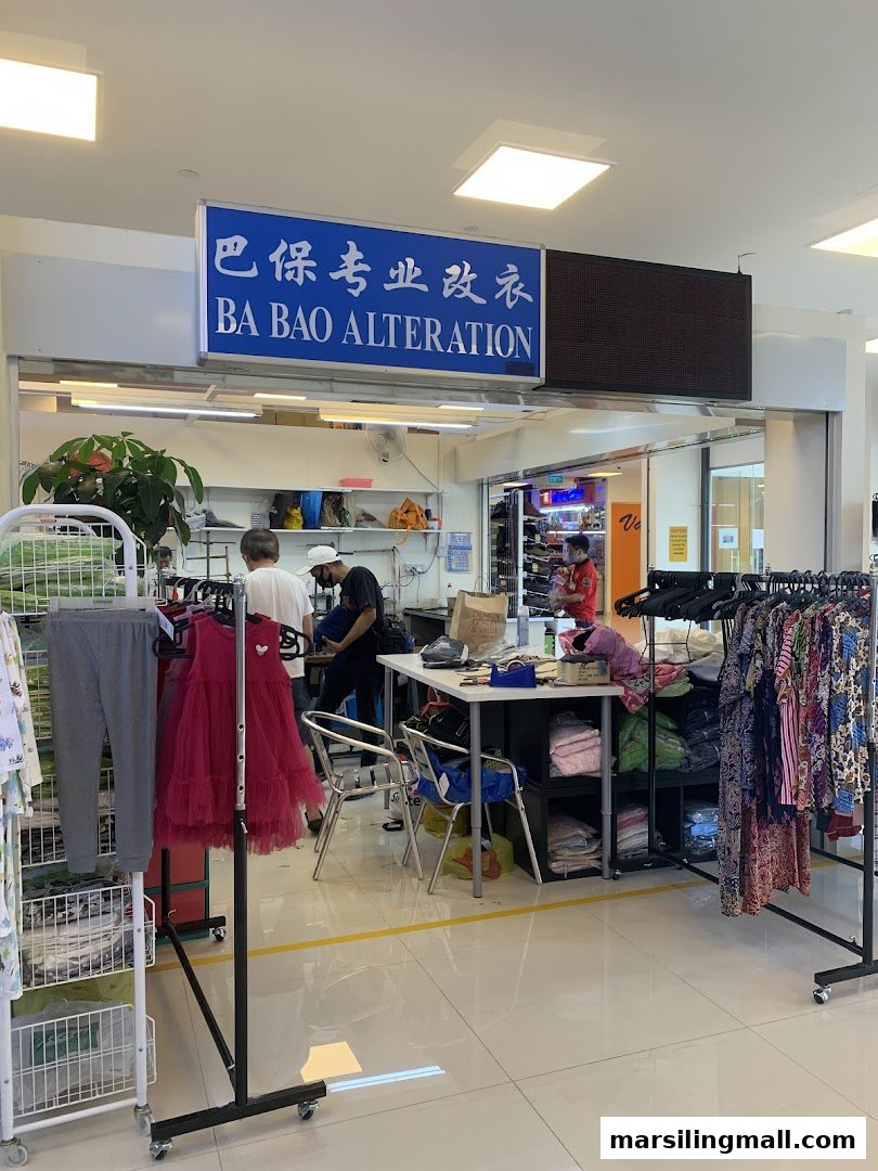 The Ba Bao Alteration shop front, showing staff working and clothing racks inside.
