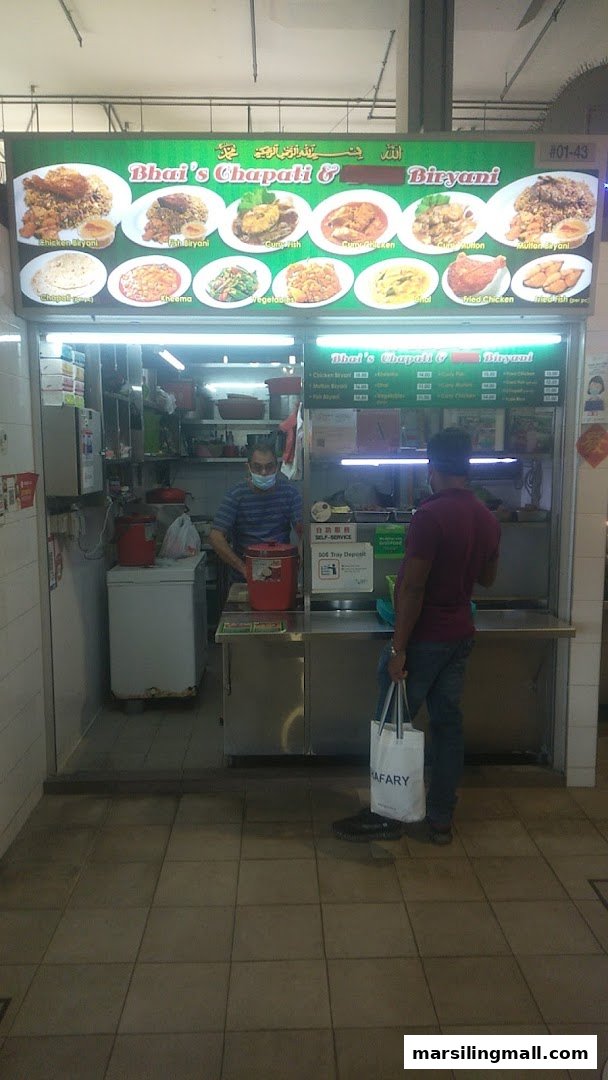 Exterior view of Bhai's Chapati & Biryani food stall with a customer waiting.