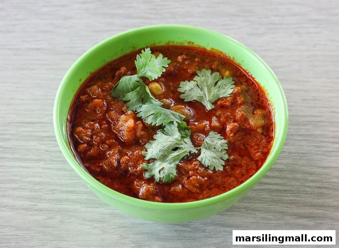 A vibrant bowl of Indian curry or stew, garnished with fresh cilantro.