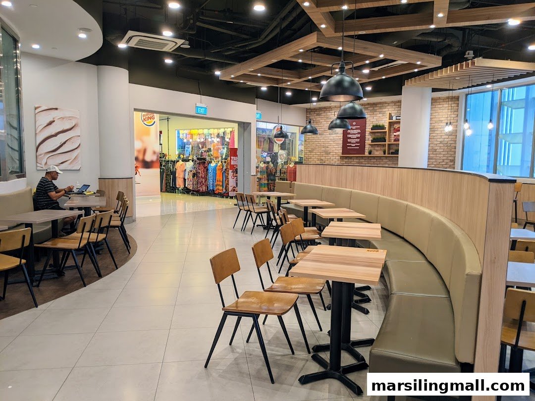 Interior view of Burger King's spacious dining area with various seating options and a glimpse of the entrance.