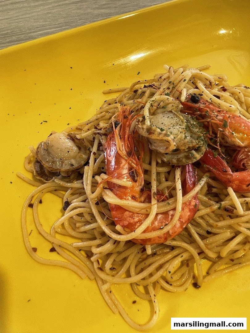 A vibrant yellow plate holds spaghetti topped with succulent shrimp and scallops.