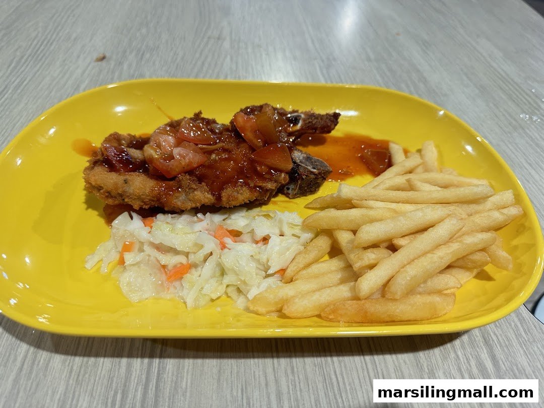 A vibrant yellow plate featuring a fried cutlet with sauce, coleslaw, and golden french fries.