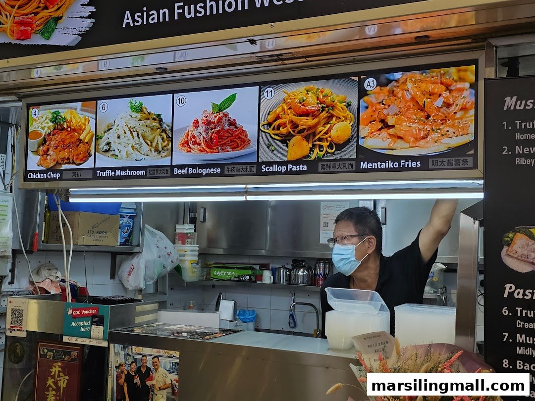 A Chef William food stall counter with a digital menu display and a staff member wearing a mask.
