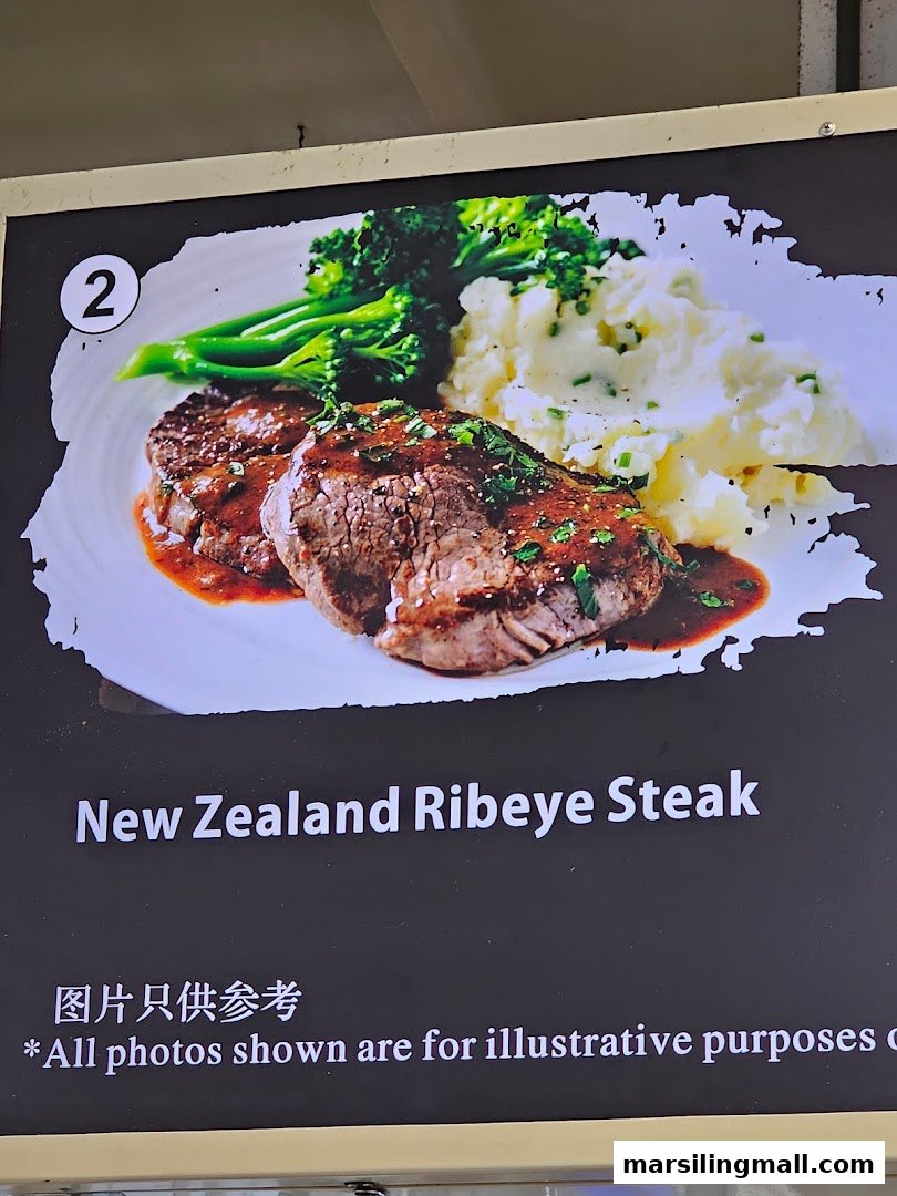 A display board showcasing a New Zealand Ribeye Steak dish with mashed potatoes and broccoli.