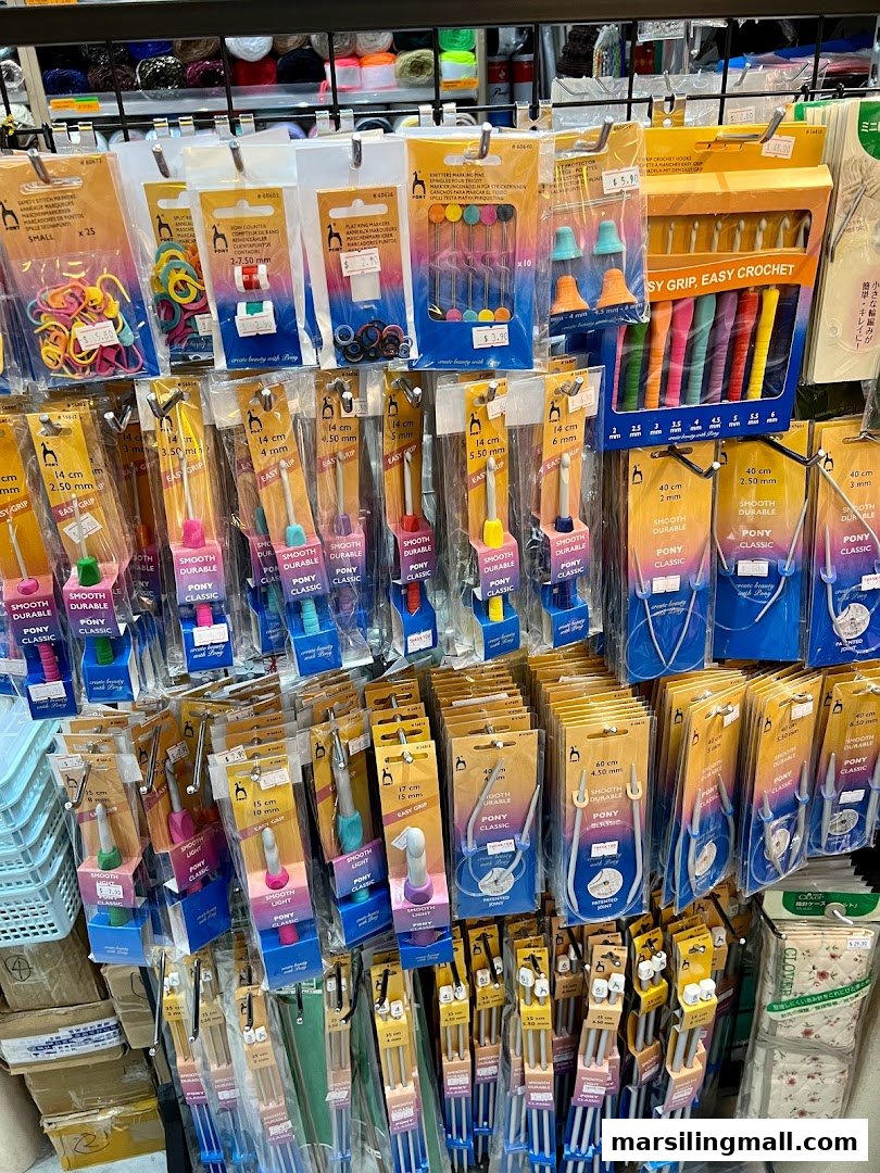 A vibrant display of knitting needles, crochet hooks, and crafting accessories at Crafting House.