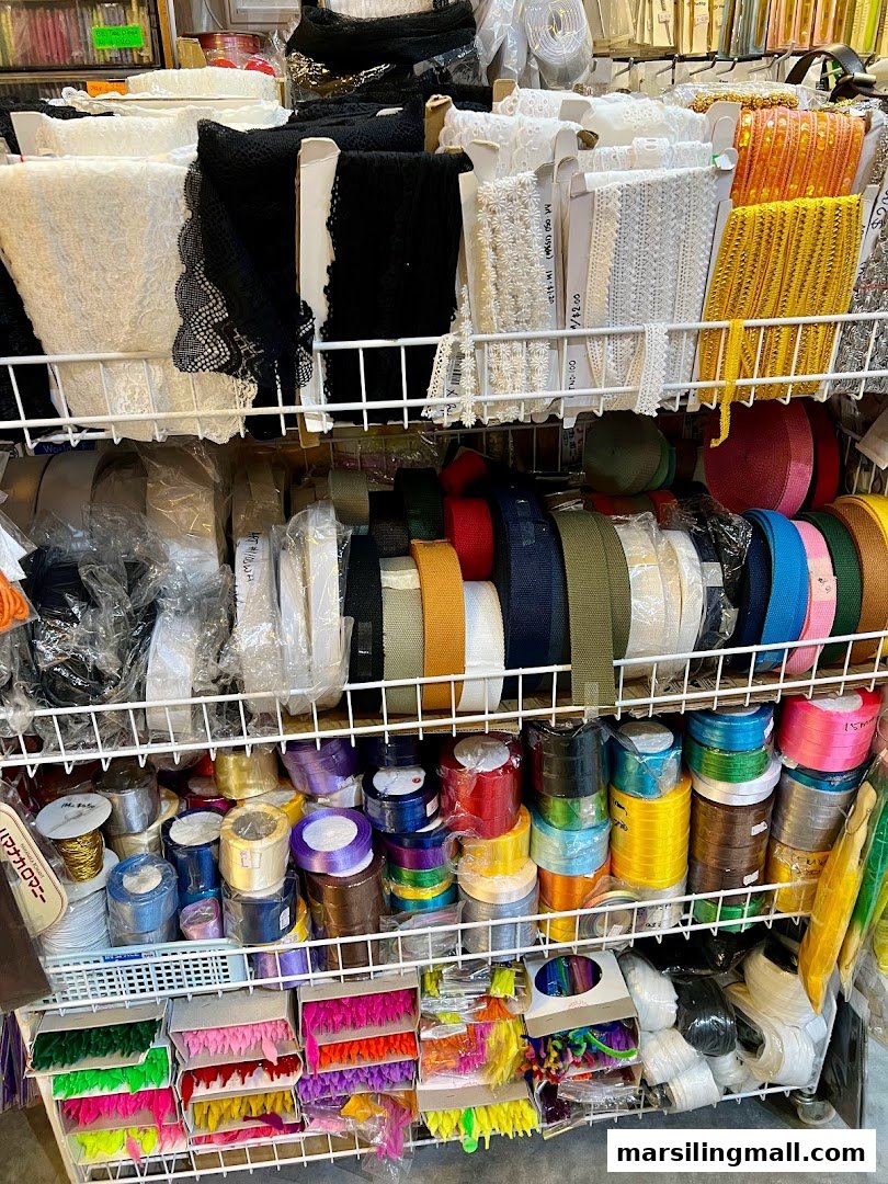 A vibrant display of colorful ribbons, laces, and various craft supplies neatly organized on shelves.
