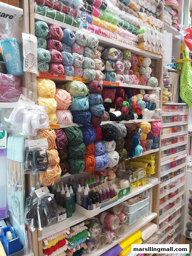 Shelves brimming with colorful yarn, craft supplies, and creative materials inside a vibrant crafting store.