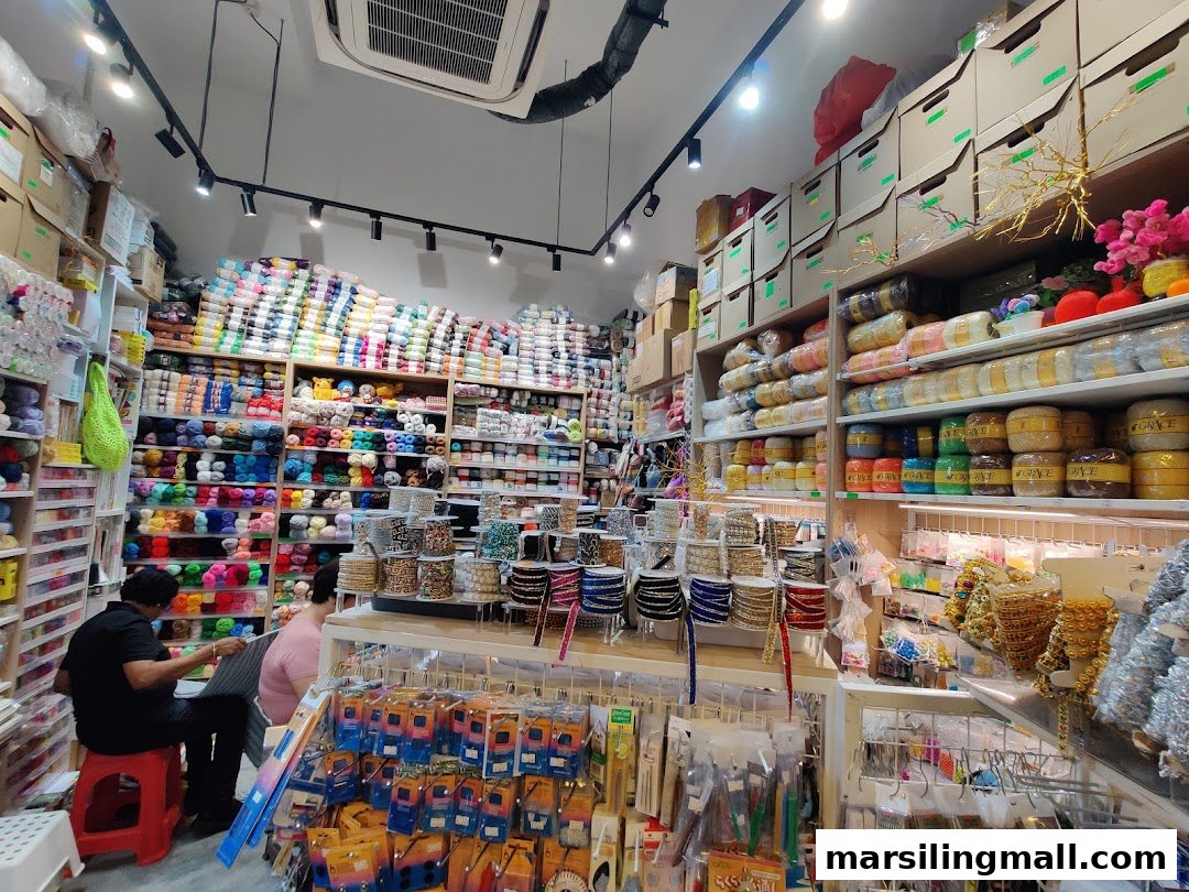 Vibrant interior of Crafting House, showcasing extensive yarn, ribbon, and craft supplies with customers browsing.