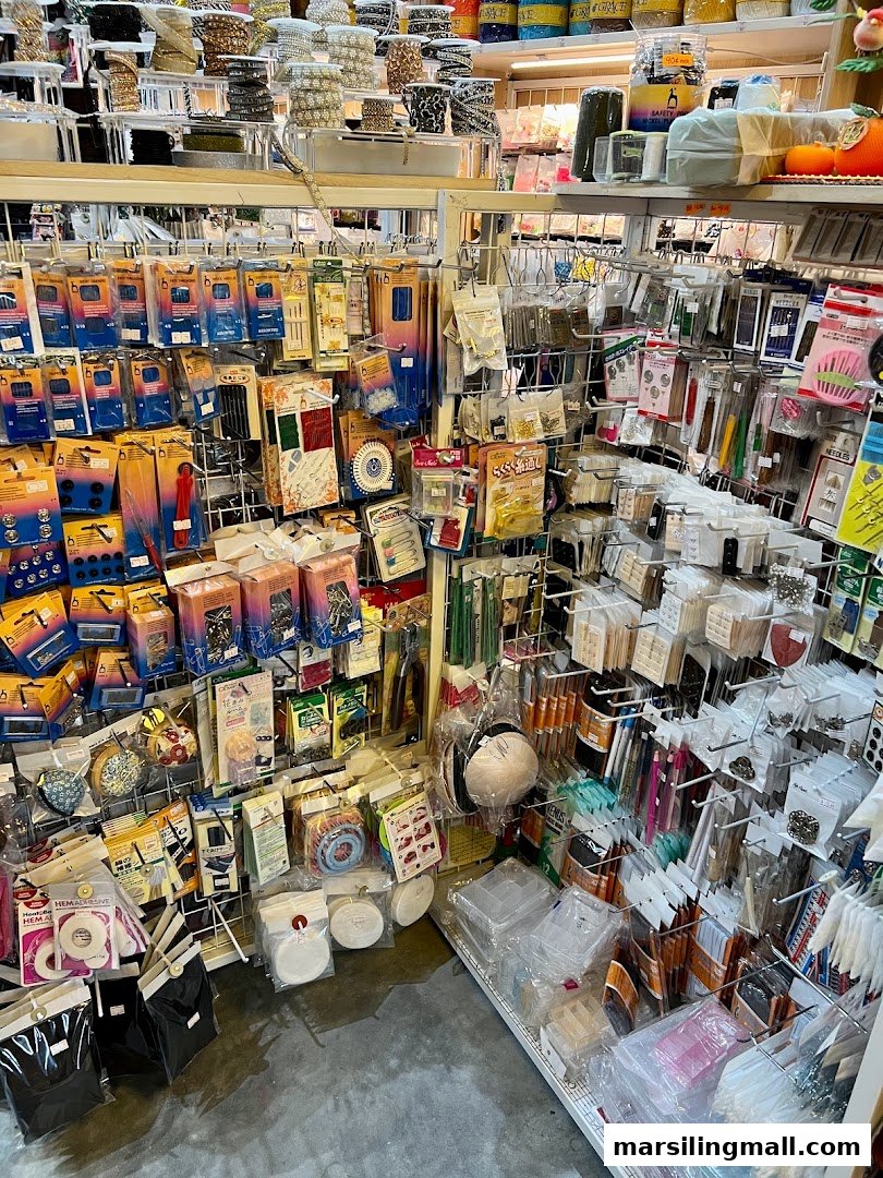 Shelves packed with a wide variety of crafting supplies, sewing notions, beads, and DIY materials.