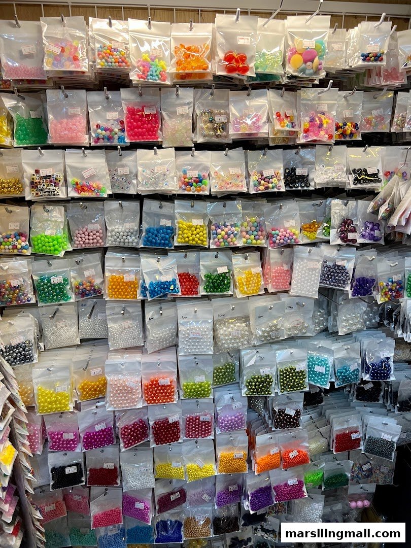 A vibrant display wall filled with countless bags of colorful beads and crafting supplies.