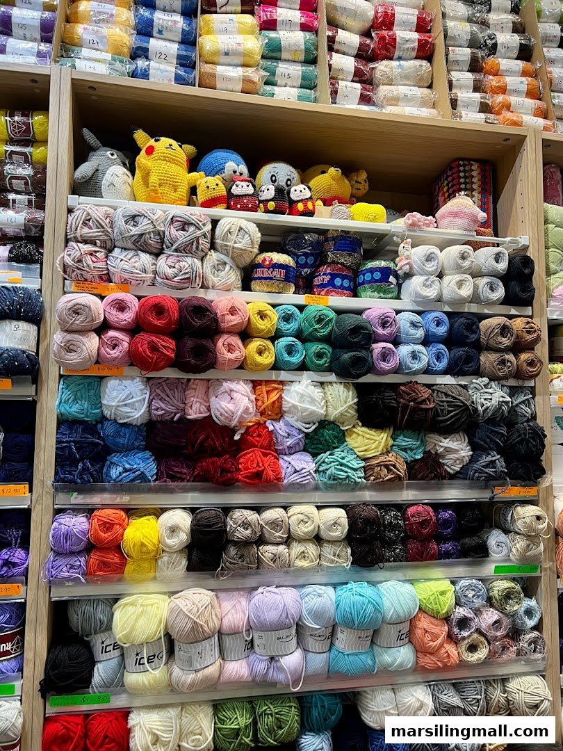 Shelves filled with colorful yarn skeins and charming crocheted characters in a craft store.