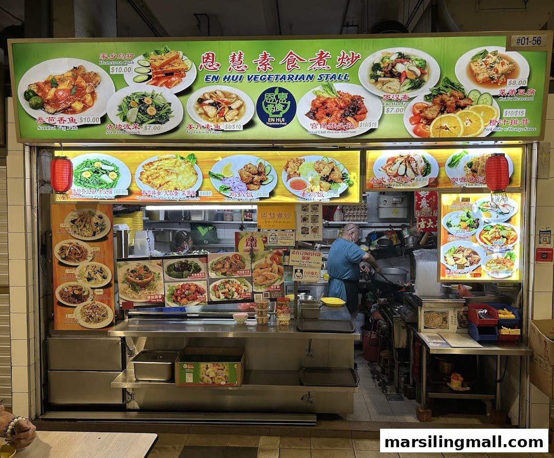 A vibrant vegetarian stall front showcasing a detailed menu board with various plant-based dishes.