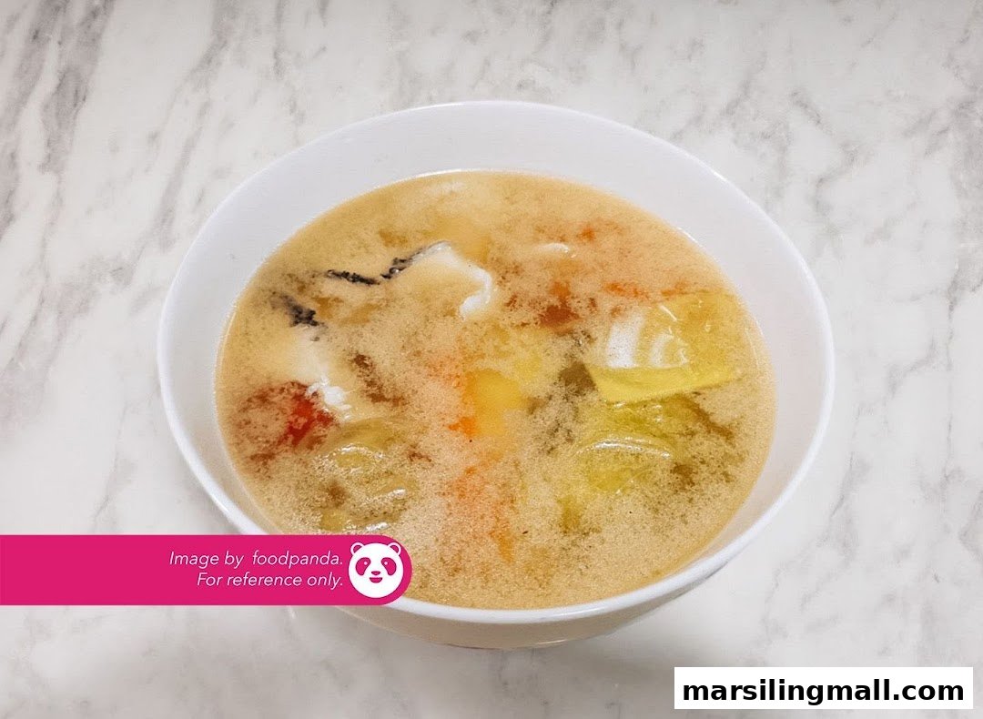 A close-up of a hearty bowl of vegetarian soup with various ingredients.
