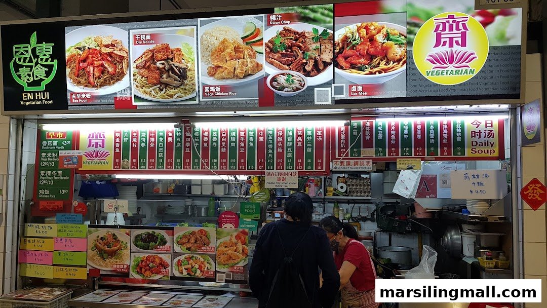 A vibrant vegetarian food stall displaying a wide array of menu items and daily specials.