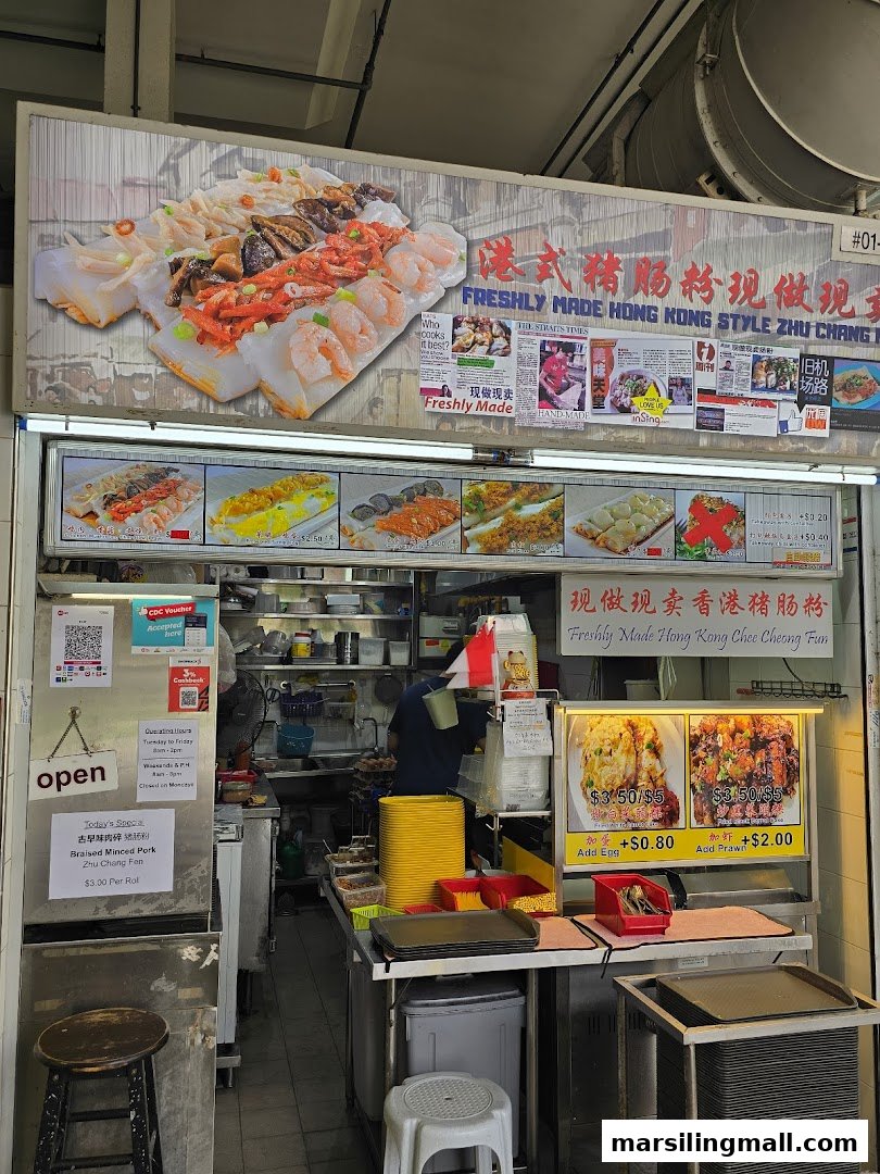 A vibrant food stall specializing in freshly made Hong Kong style chee cheong fun, with various toppings.