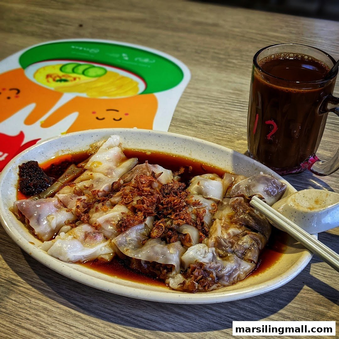 A delicious plate of Hong Kong style chee cheong fun with a side of chili and a beverage.