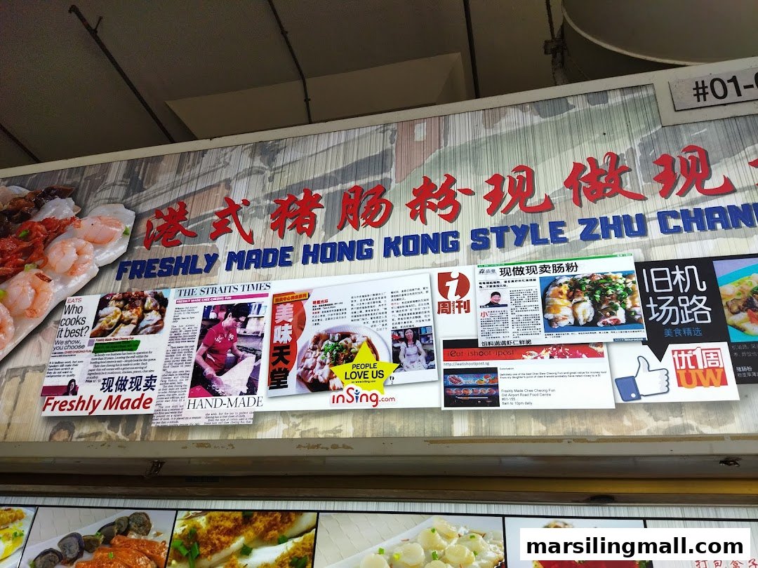 Close-up of the shop sign for 'Freshly Made Hong Kong Style Zhu Chang Fen' featuring press clippings and food images.