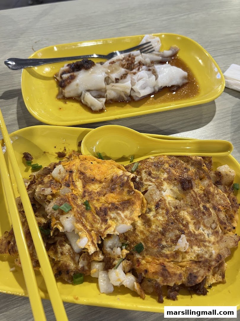 Two plates of Hong Kong style dishes, including chee cheong fun and fried carrot cake, served on yellow plates.