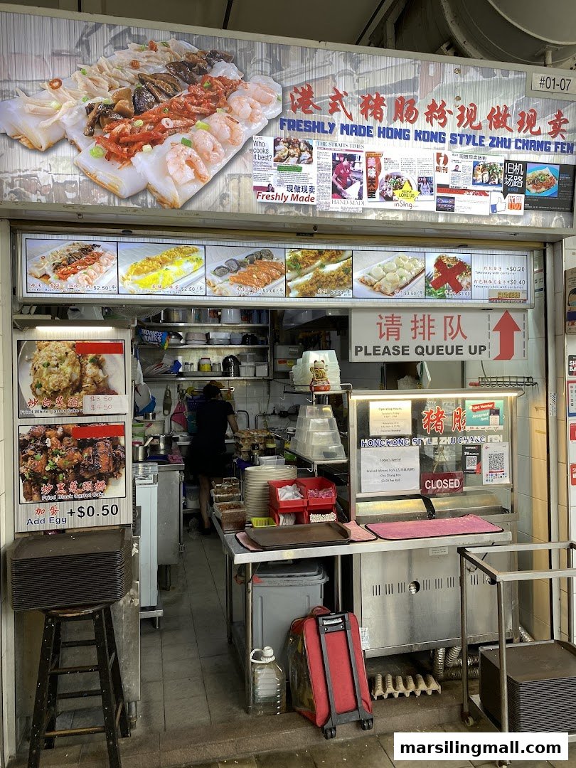 A vibrant storefront showcasing various freshly made Hong Kong style Chee Cheong Fun and carrot cake dishes.