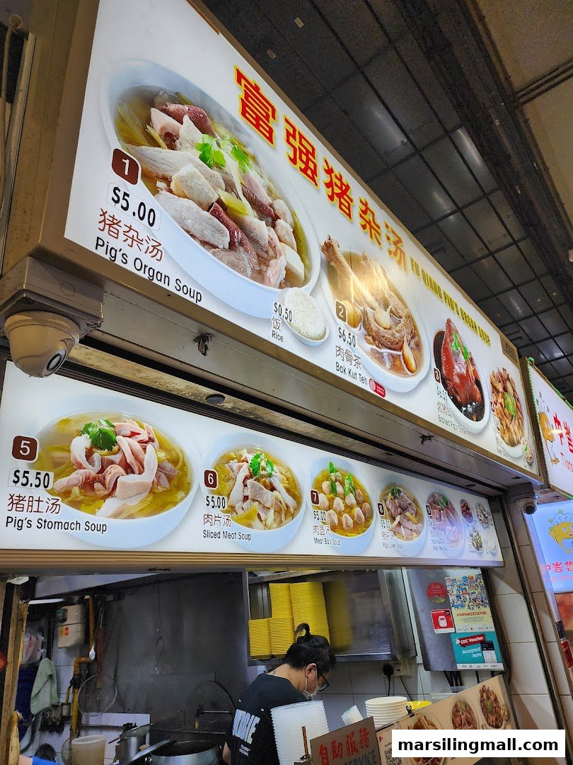 An illuminated menu board at a hawker stall displaying various traditional Chinese soups and dishes.