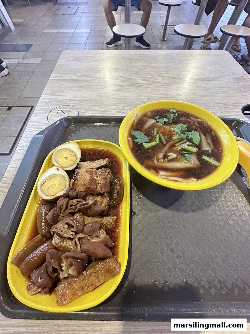 A tray featuring a bowl of pig organ soup and a plate of braised pork belly, intestines, and eggs.