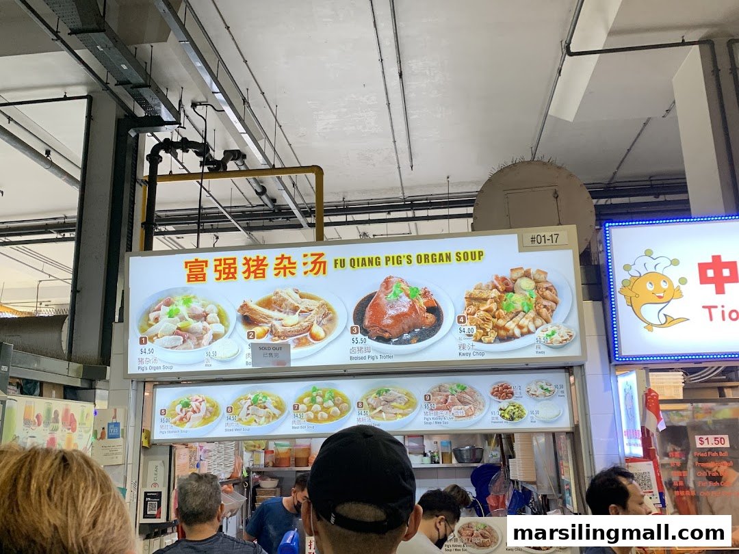 A vibrant menu board displaying various traditional pig organ soup and braised dishes with prices.