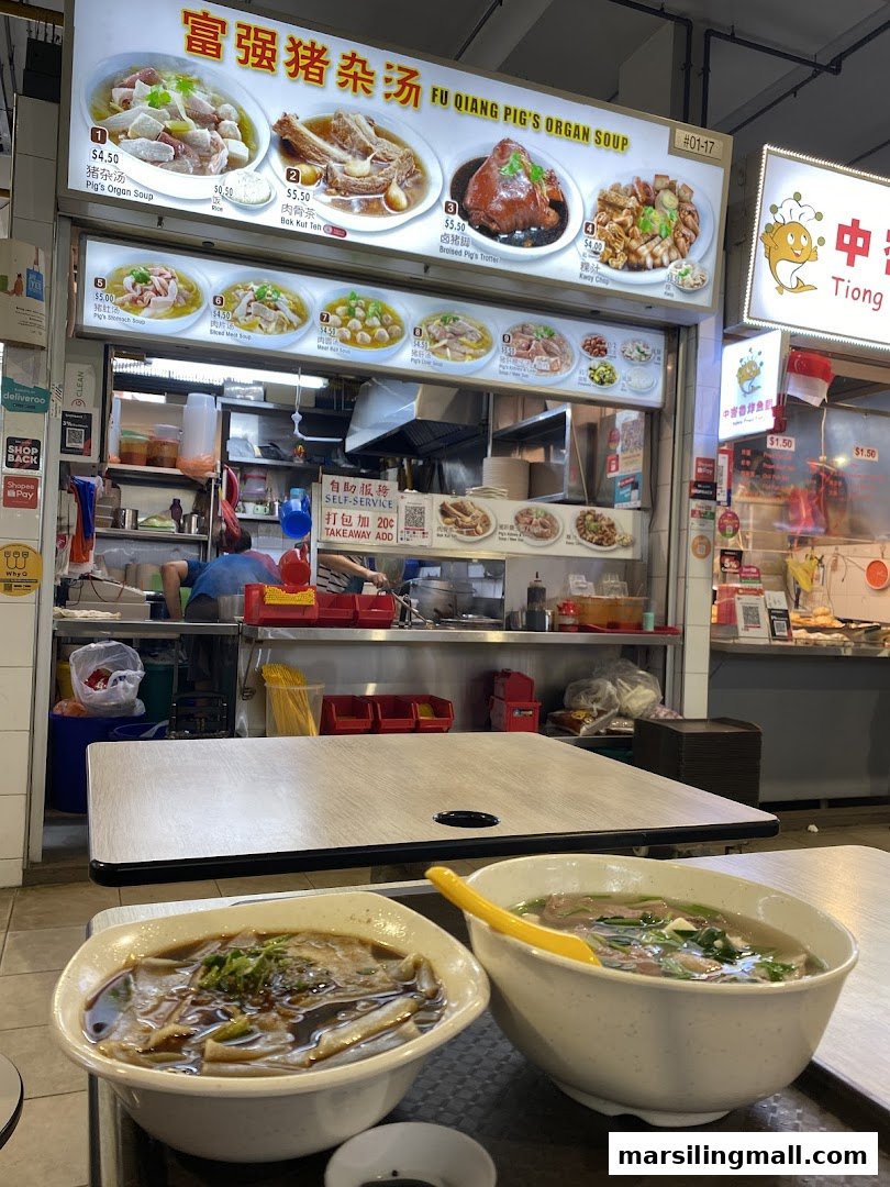 A food stall's menu board displaying various traditional Chinese soups and dishes, with two bowls of soup on a table.