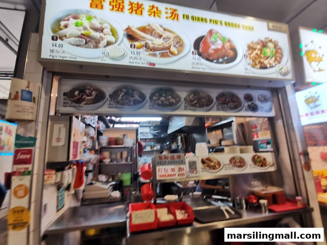A food stall displaying its menu board with various traditional Chinese soups and dishes.