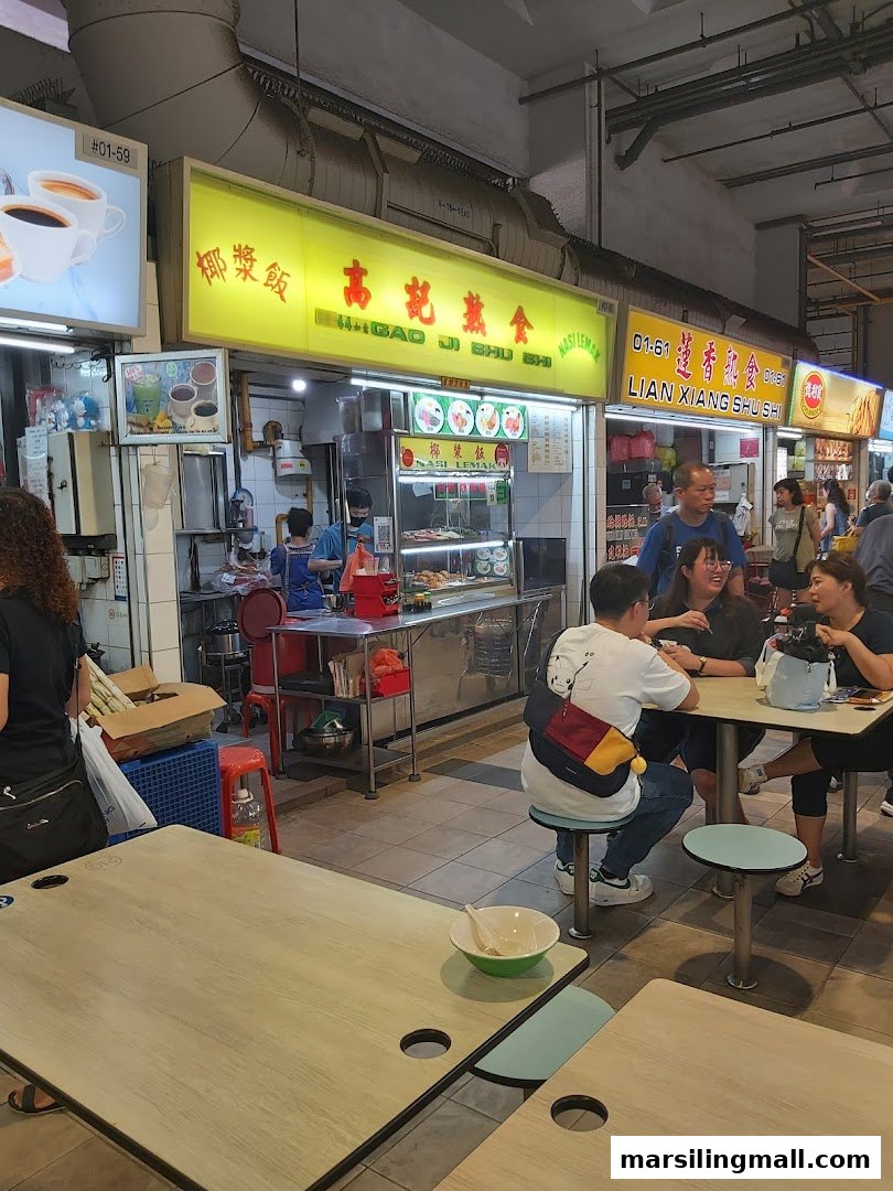 A bustling food stall, 'Gao Ji Shu Shi Nasi Lemak', with customers enjoying traditional dishes in a vibrant setting.