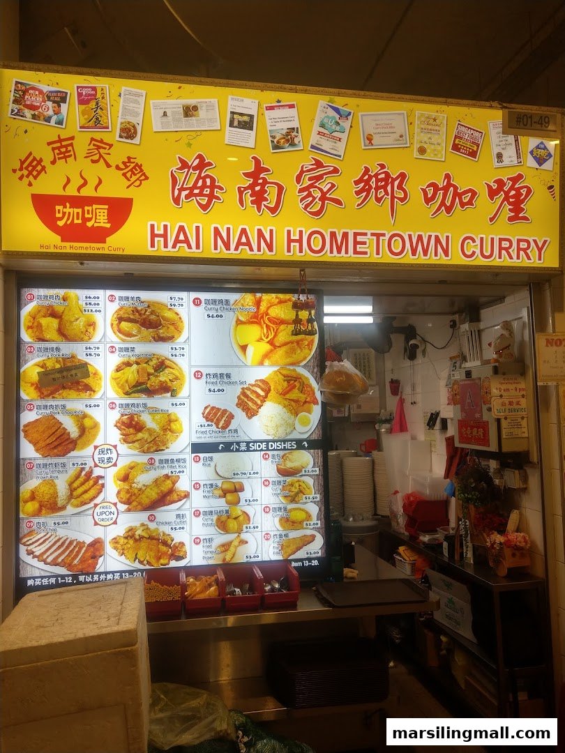 The storefront of Hai Nan Hometown Curry, featuring its vibrant signage and a detailed menu display.