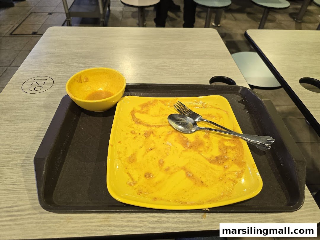 An empty plate and bowl on a table after a meal, indicating a satisfied customer.