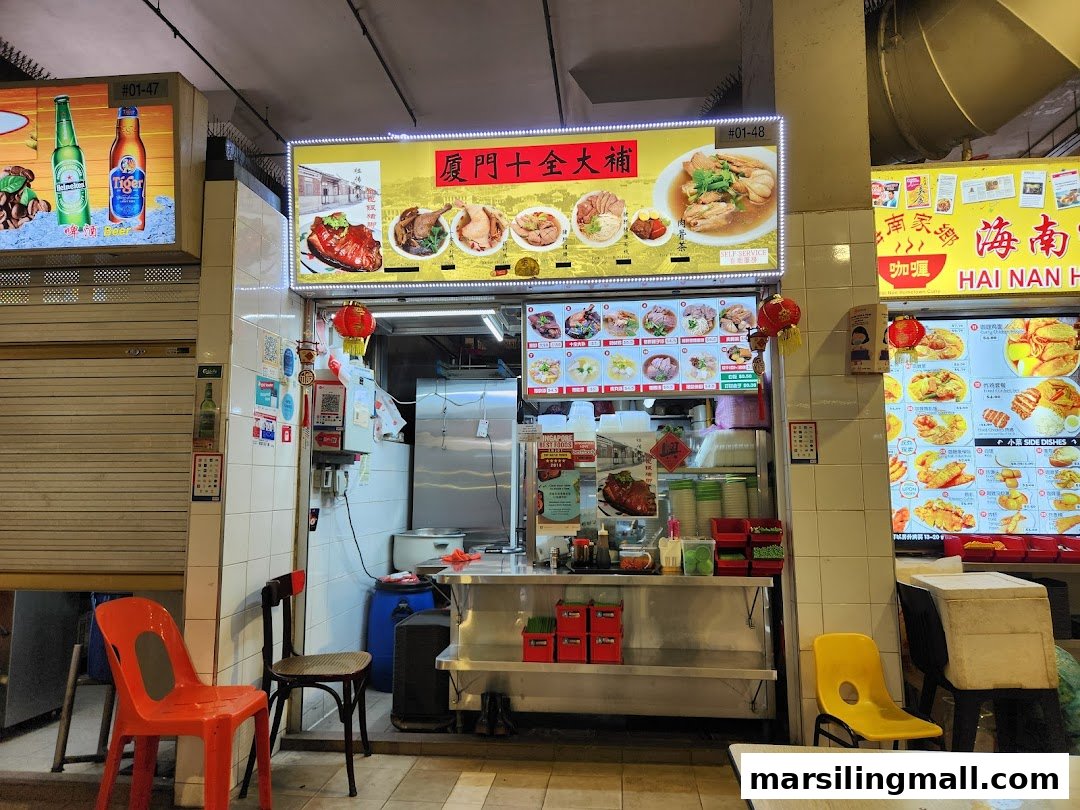 A vibrant food stall entrance featuring a large illuminated menu board and traditional Chinese lanterns.
