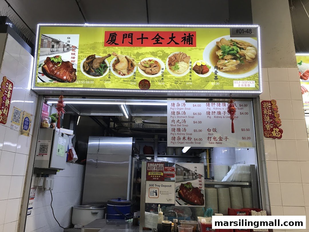 A brightly lit food stall front featuring a signboard with various herbal soup dishes and a detailed menu.