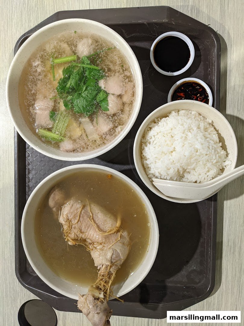 Two bowls of traditional Chinese soup, one with pork and vegetables, the other with ginseng chicken, served with rice and sauces.