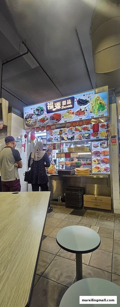 Customers ordering at Hock Guan Desserts stall, featuring a vibrant menu board and dessert display.