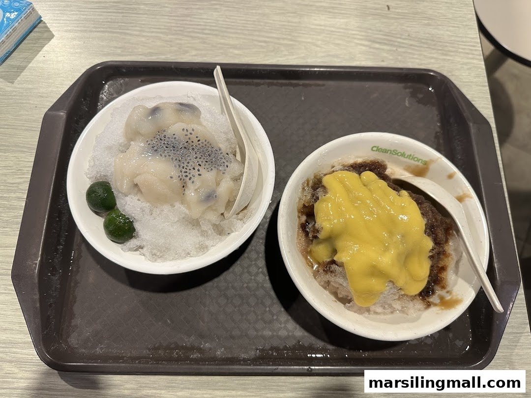 Two bowls of refreshing Asian desserts, one with mango and the other with basil seeds, served on a tray.
