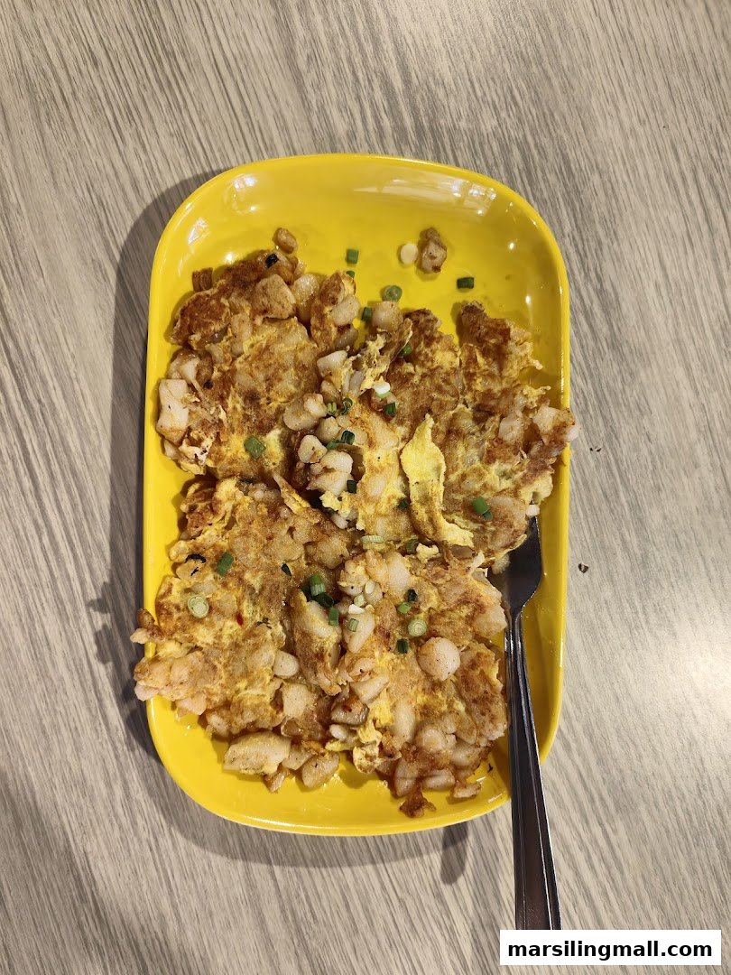 A vibrant yellow plate holds a serving of savory fried carrot cake, garnished with spring onions.
