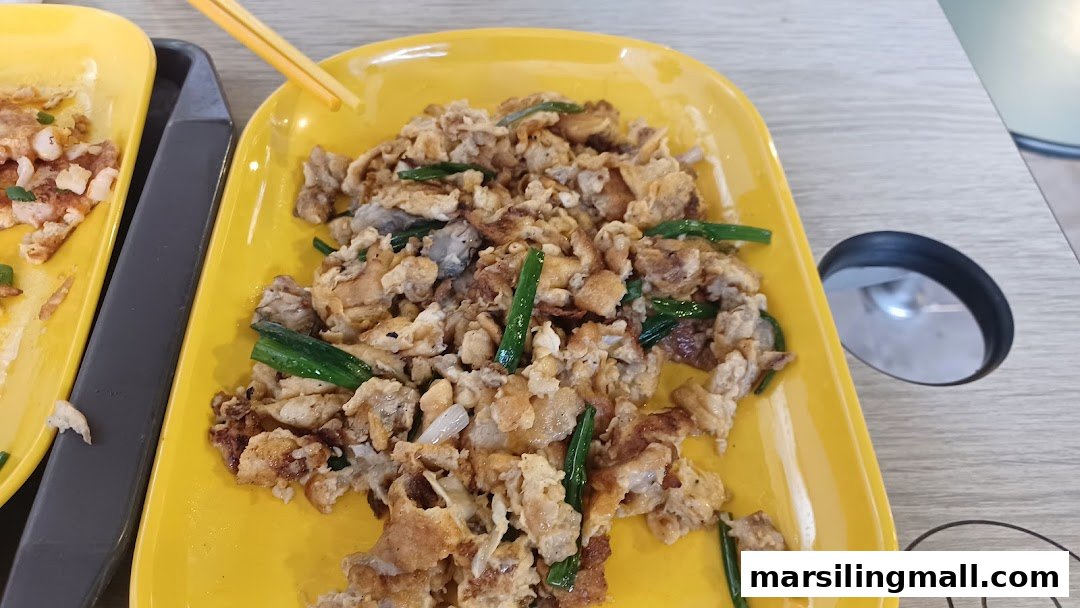 A vibrant yellow plate holds a serving of savory fried carrot cake with green onions.