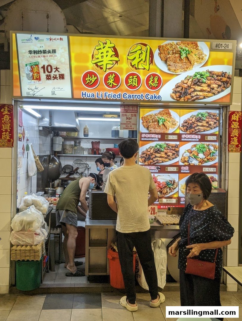 A bustling hawker stall, Hua Li Fried Carrot Cake, with customers and staff, showcasing its signboard and offerings.