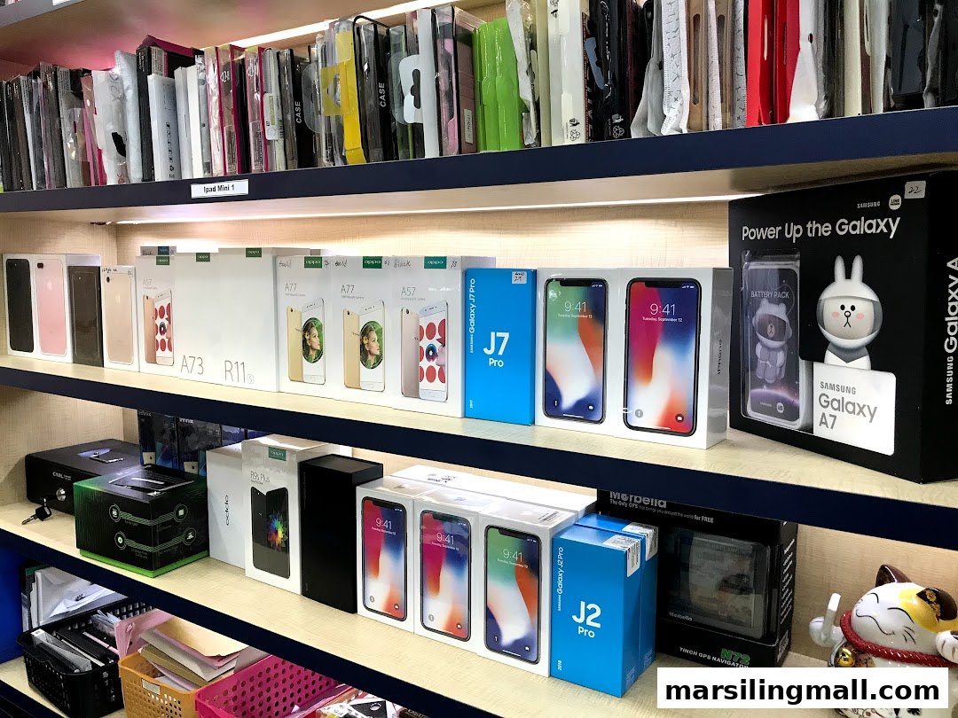 Shelves filled with various mobile phones, accessories, and electronics on display at ImobileHub.