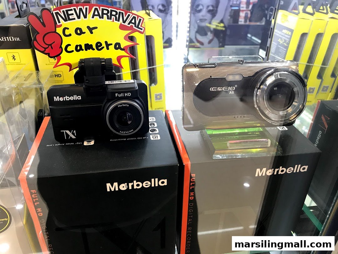 Two 'Marbella' brand car cameras, one labeled 'NEW ARRIVAL', displayed in a retail shop.