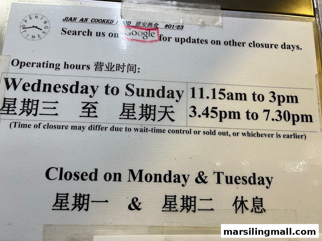 A sign displaying Jian An Cooked Food's operating hours and closure days.