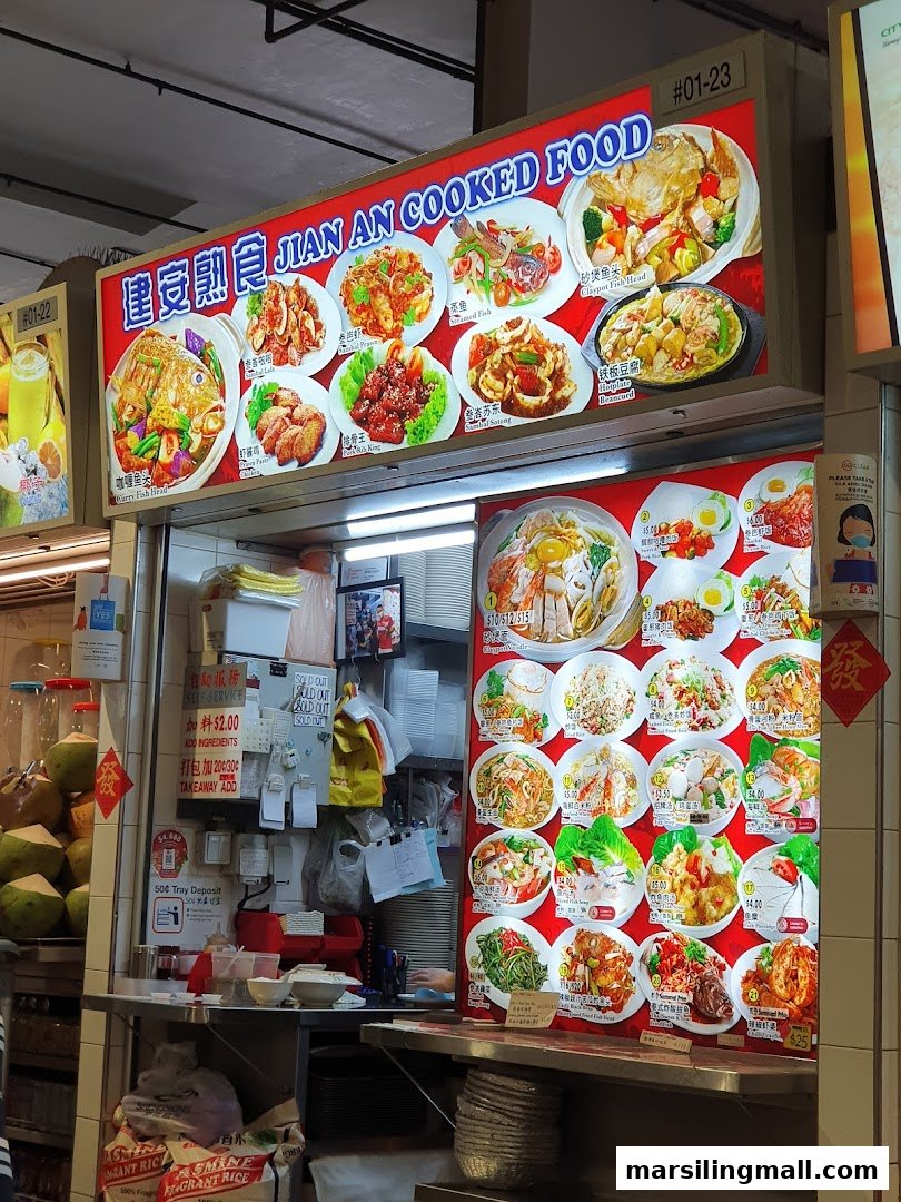 A vibrant hawker stall displaying a wide array of cooked food dishes and menu items with prices.