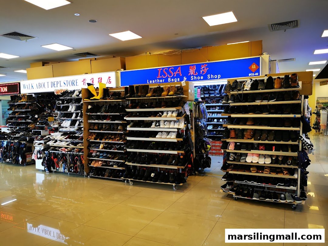 Interior view of a shoe and leather goods shop, featuring multiple racks of diverse footwear.