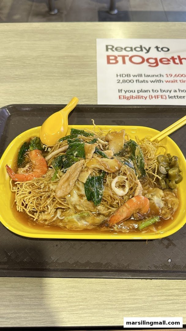 A delicious plate of crispy noodles with seafood and vegetables in savory gravy.