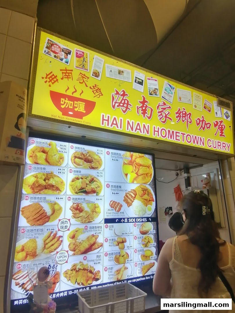 A vibrant digital menu board showcasing Hainanese curry dishes and sides at a hawker centre.