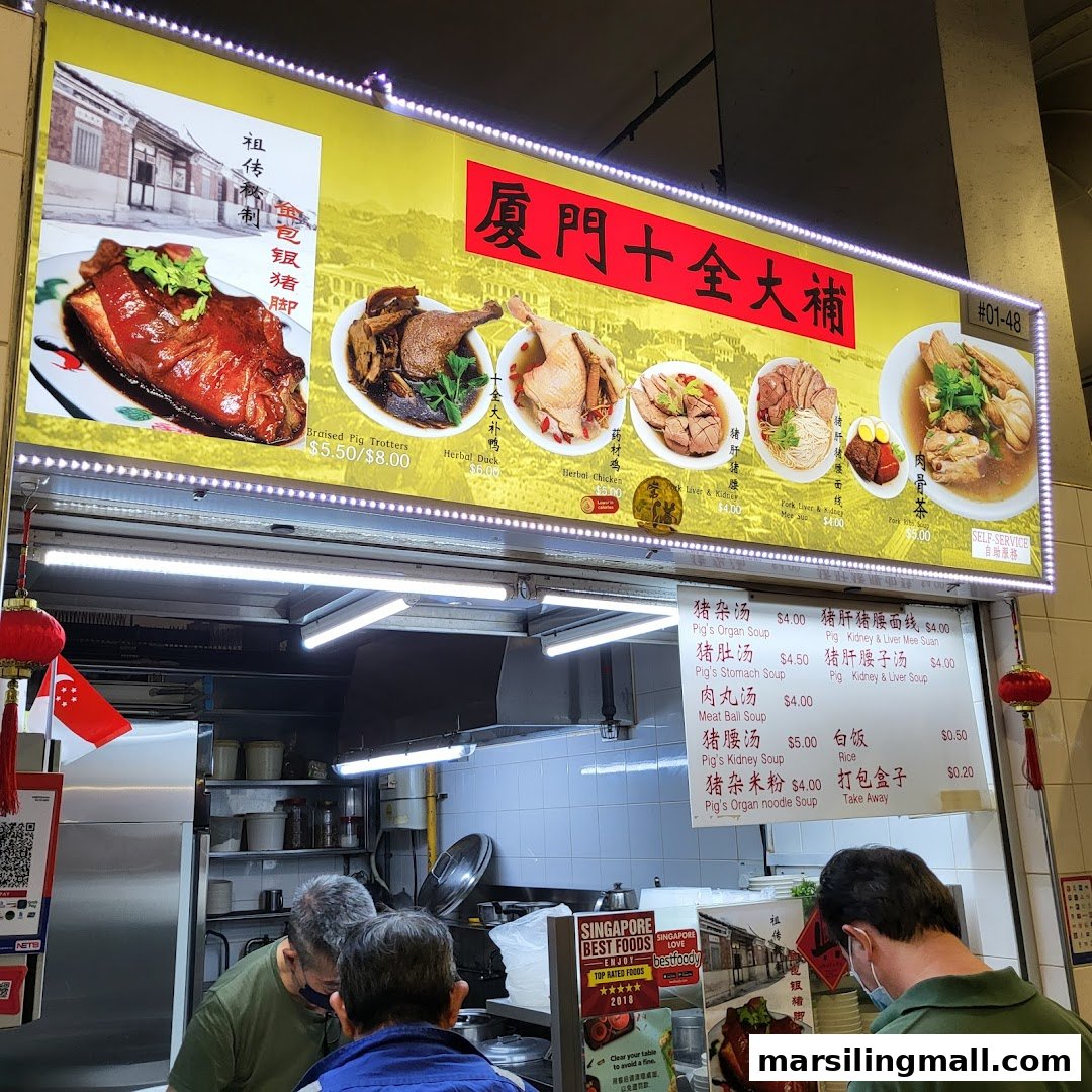 A bustling hawker stall featuring a large illuminated menu board with traditional Chinese dishes.