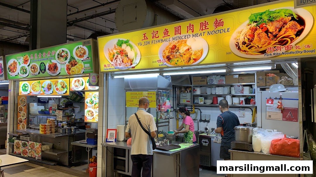 Customers order food at two bustling hawker stalls, Yu Jih Fishball and En Mu Vegetarian, in Marsiling Mall Hawker Centre.