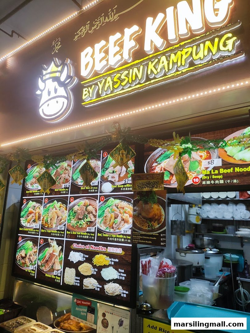 A vibrant hawker stall, 'Beef King by Yassin Kampung,' showcasing its menu and offerings.